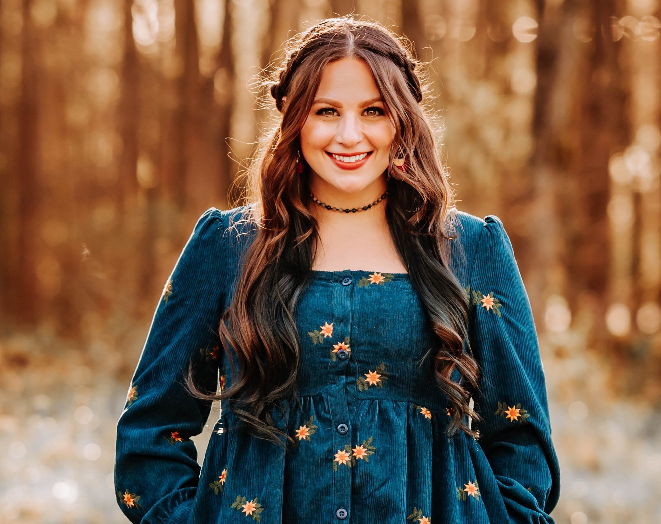 Maggie McDonald smiling in a forest